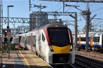 Outbound EMU's come into the station past another